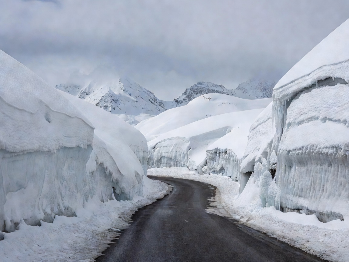 Grossglockner High Alpine Road winding between high snow walls near the Hochtor tunnel in early season